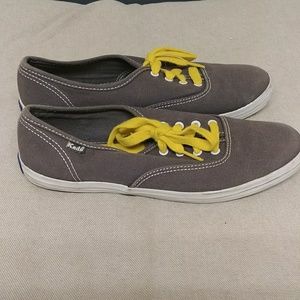 grey keds with yellow laces
